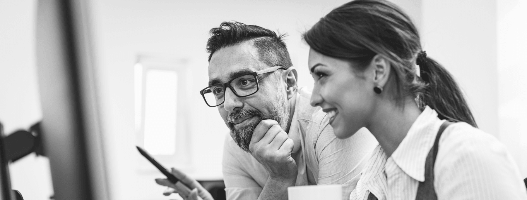 Two people smile while at new system for sales rep adoption